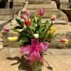 A lively, color-forward tulip bouquet designed to instantly brighten moods and add