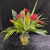 Bright, energetic tropical blooms make this flower arrangement a joyful choice to