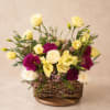 A delicate garden-style floral basket designed with soft ivory roses, lisianthus, rich