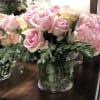 Pink and cream roses with hydrangeas in a glass vase