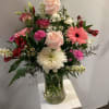 A beautiful, spring-flower-filled arrangement for Mother's Day. Includes a variety of pink