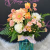 Peach and blush gerbera daisies and tulips take center stage in this
