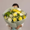 A soft and refreshing bouquet in delicate yellow and white tones, featuring