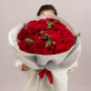 A timeless bouquet of 24 premium red roses, each bloom rich in