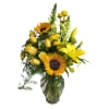 Yellow bouquet with sunflowers, roses, lilies, and snapdragons in a glass vase