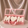 A refined and elegant gift featuring delicate white rose soaps beautifully arranged
