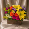 A joyful, florist-designed flower arrangement featuring a vibrant mix of seasonal blooms