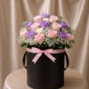 An elegant flower arrangement featuring 24 roses in soft blush, lavender, and