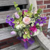 Elegant arrangement including peony and orchid. 