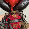 Red rose bouquet with black wrapping and heart balloons