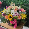 A beautifully balanced arrangement of bright cheerful flowers designed to bring joy