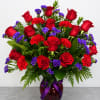 12 red roses, 6 carnation, and premium assorted statice filler. Arrangement is