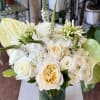 Whites and greens in a clear glass vase.