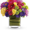 Hot-pink roses and tulips pair with sunny yellow roses and tulips, accented