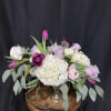 Pink and white floral arrangement in a clear glass vase