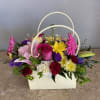 With vibrant floral gift is beautifully arranged with seasonal blooms designed by