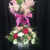 Two-tier floral arrangement with pink lilies and mixed blooms in a metal bucket