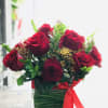 Beautiful red roses and baby breath and some greenery 