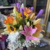 Bright pink lilies and sunny sunflowers take center stage in this celebratory