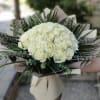Bouquet of white roses with greenery and beige wrapping