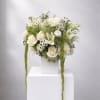 White floral arrangement with roses and lilies in a white vase