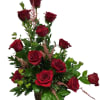 Basket arrangement of red roses with pink filler flowers