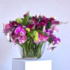 A lush mix of hot pink orchids, magenta calla lilies and soft