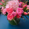 A mix of vibrant pink hydrangea,roses, tulips and peonies with a variety