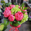 an elegant arrangement of pink  peonies with a small touch of