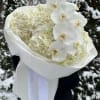 White hydrangea and orchid bouquet wrapped in white paper