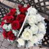 Basket of red and white roses with silver foliage