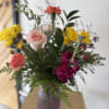 A cheerful Mother&rsquo;s Day bouquet filled with bright yellow, pink, coral, and