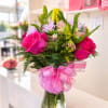 Mixed floral arrangement including gerberas, daisies, roses, and lilies.