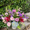 Fantastical lilies, enchanting hydrangea, and whimsical roses come together to create a