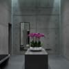 Pink orchids arranged in a white bowl on a pedestal