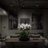 White orchids in a low black planter on a table