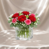 A romantic flower arrangement designed in a modern glass cube, featuring rich