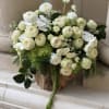 Neutral colors flowers beautifully designed in a teak wood vase