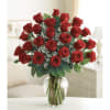 Two dozen red roses arranged in a classic rounded cluster make a