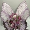 Butterfly-shaped floral arrangement with pink roses and alstroemeria