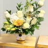Cream-white roses and a cloud of white hydrangea meet sunny yellow tulips