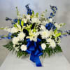 White and blue floral arrangement with a large blue ribbon
