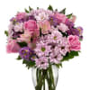 Pink and purple mixed bouquet in a clear glass vase