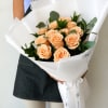 Dozen Peach Roses with greenery and decorative wrapping paper. All bouquets come