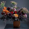 A dramatic, sculptural mixed flower arrangement that reads like twilight in bloom-Dusk