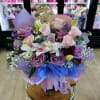 Lavender and pink roses fused with white lilies create a soft, romantic