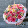 A soft, romantic composition built around lush pink garden roses, designed to