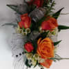 Spray Rose Corsage with assorted greens and filler. Colors and ribbons may