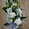 White rose corsage with silver ribbon and pearl accents