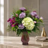 Lavender roses and a single voluminous green hydrangea create the soft focal